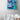 Painting of a woman diving under waves with two whales hanging on the wall above a bathtub.