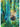 Painting of a seal swimming upside down through giant kelp forest. A second seal can be seen behind a swarm of fish.