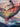 Detail of whale fin and expressive abstract elementsin portrait of a woman underwater surrounded by whales.