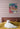 Tiger painting on bedroom wall above a bed with a cat.