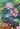 Water lily close up in painting of tiger lying in water above a water fall.