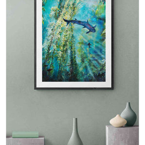 Framed painting of an underwater kelp forest hanging on a wall above decorative vases