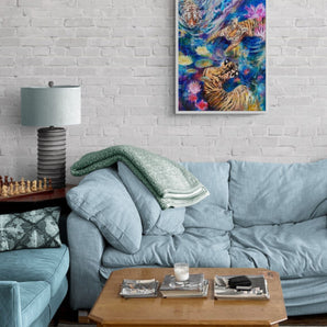 Abstract Realism painting of three tigers lying in water surrounded by water lilies. Framed oil painting hanging in a living room. 