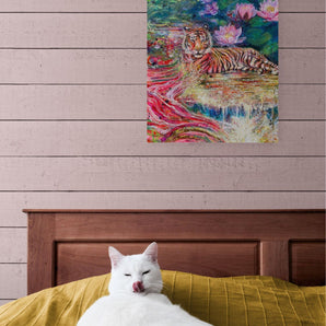 Tiger painting on bedroom wall above a bed with a cat. 